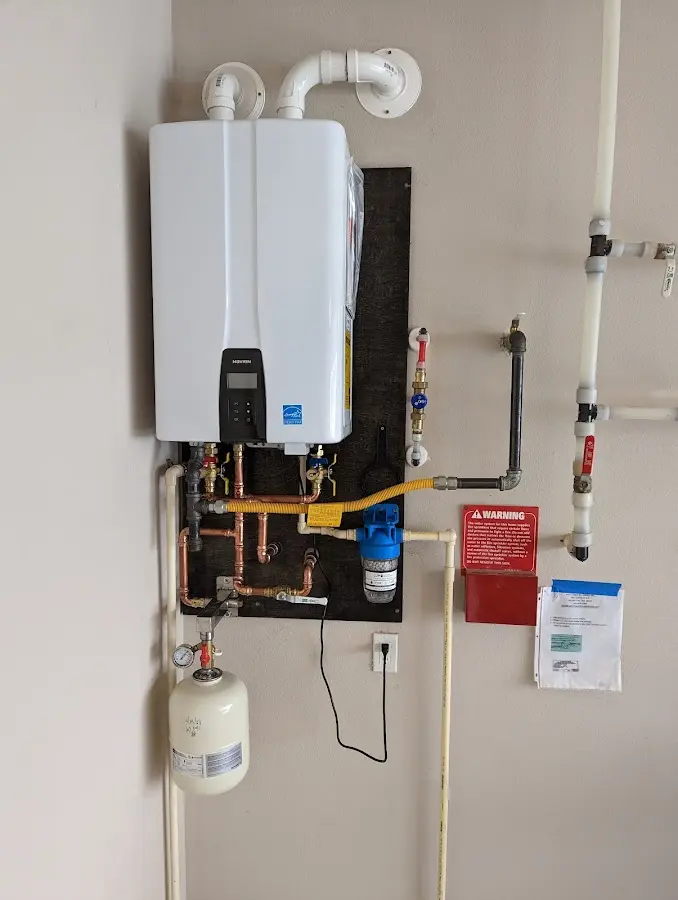 Professional plumber installing copper piping in a Thetford home